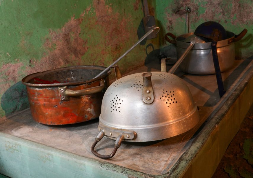 olla de cobre antigua y colador de aluminio de una casa rural sin gente